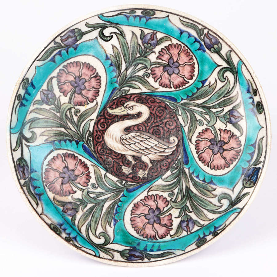A rare Arts & Crafts earthenware Persian style dish with a Swan